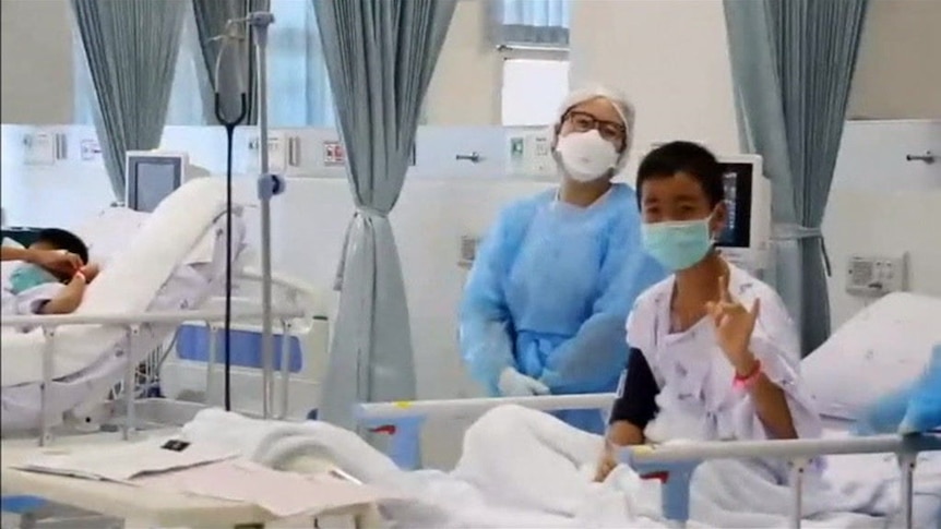 The boys rescued from a flooded Thai cave were seen smiling and chatting from their hospital beds.