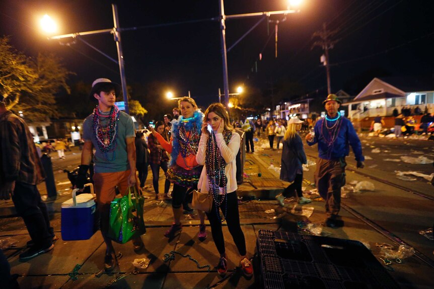 Revellers leave the scene of the Endymion parade crash.