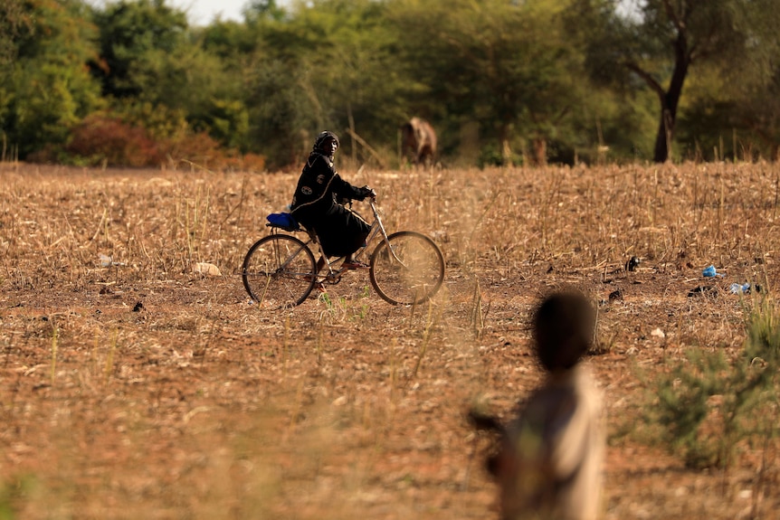 A child who fled with his parents from attacks of armed militants in the Sahel region
