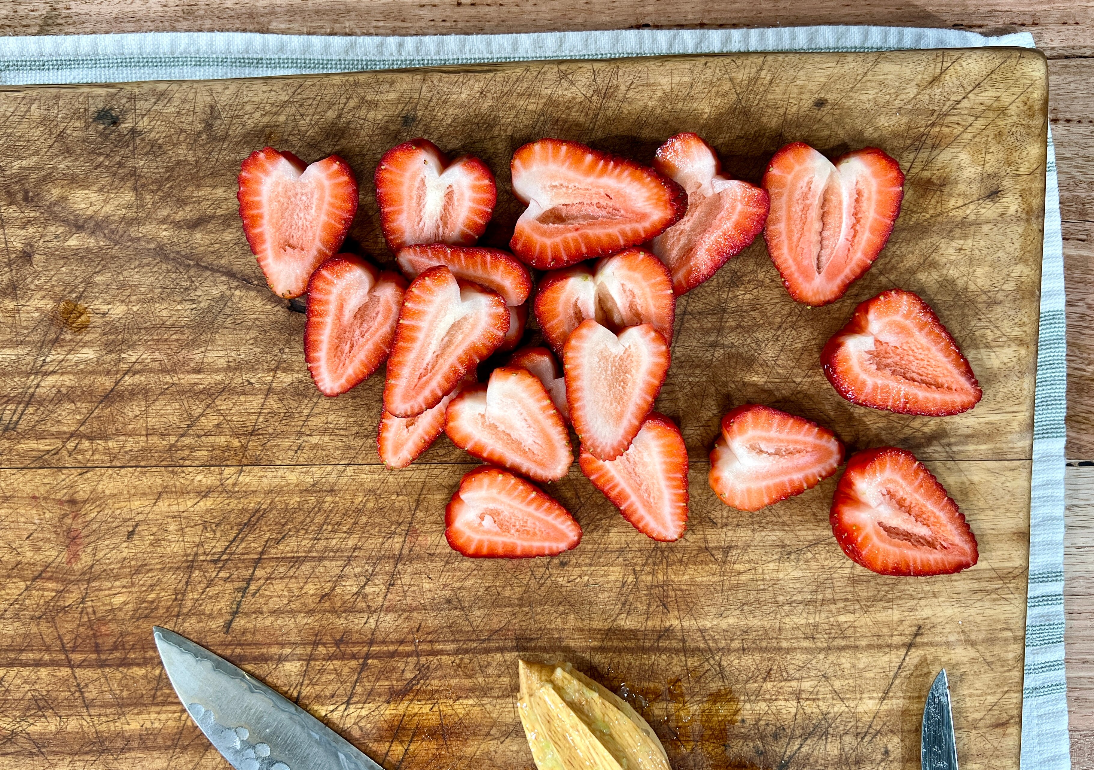 chopped strawberry hearts on chopping board