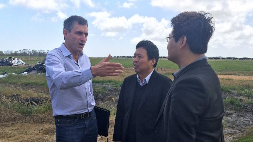 VDL CEO David Beca shows buyer Lu Xianfeng, centre, and Sean Shwe