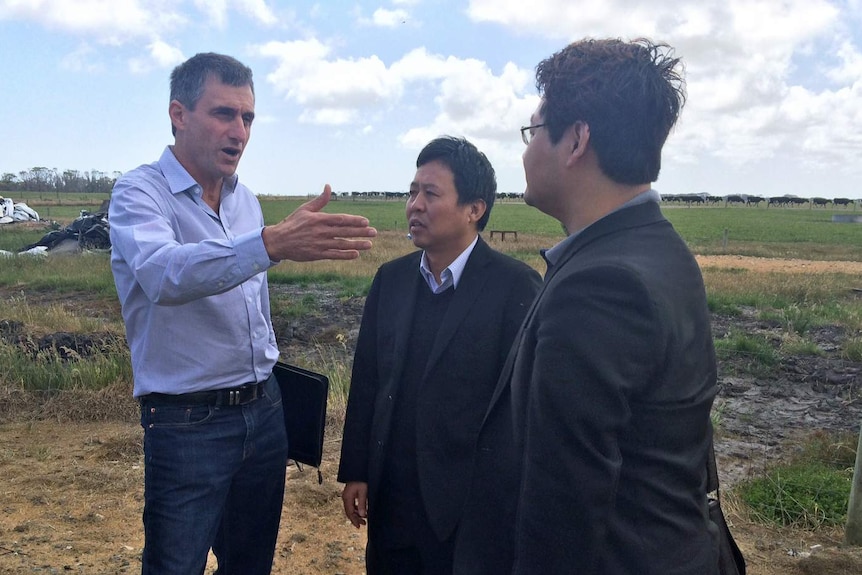 VDL CEO David Beca shows buyer Lu Xianfeng, centre, and Sean Shwe