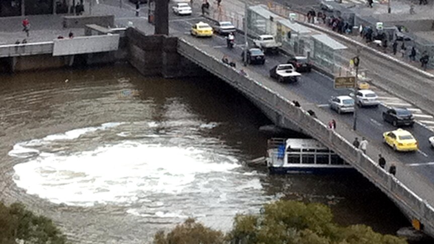 A ferry tries to power its way out from under the Spencer Street bridge.