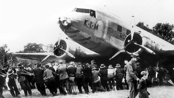 Men and children pull the Uiver aircraft out of the mud at Albury