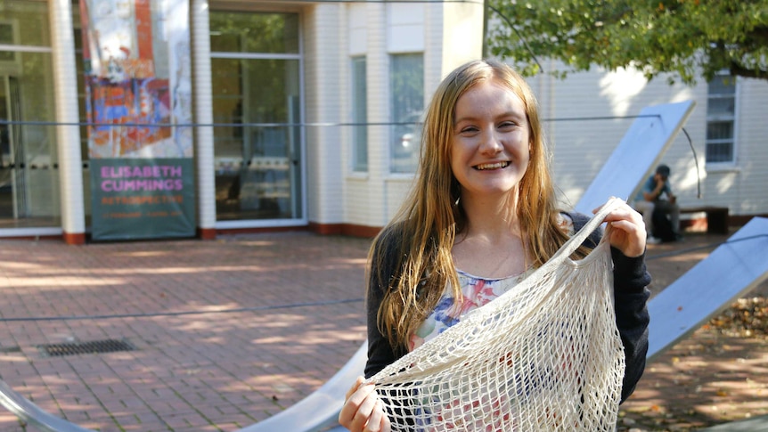 Sarah Power poses with reusable bags