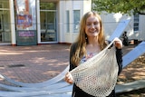 Sarah Power poses with reusable bags