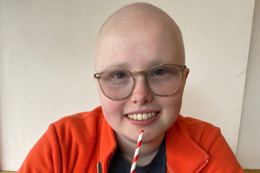 A young cancer patient with a milkshake.