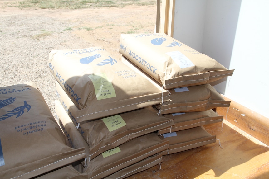 Bags stacked on a shelf.