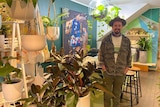 A man smiles at the camera in a homewares shop