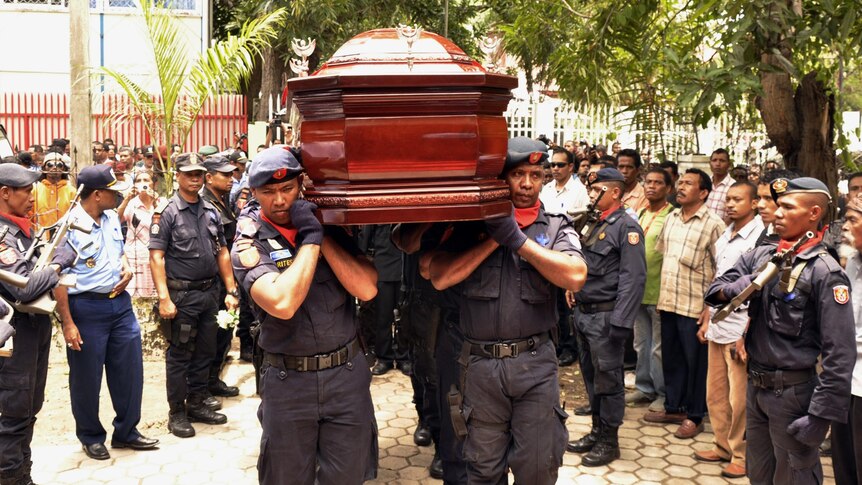 East Timorese officials carry a coffin holding Francisco Xavier de Amaral in Dili.