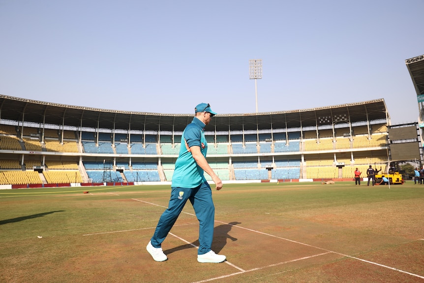 Steve Smith looks at a pitch inside a stadium