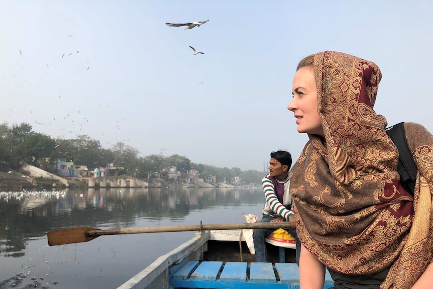 Heanue in boat on river.