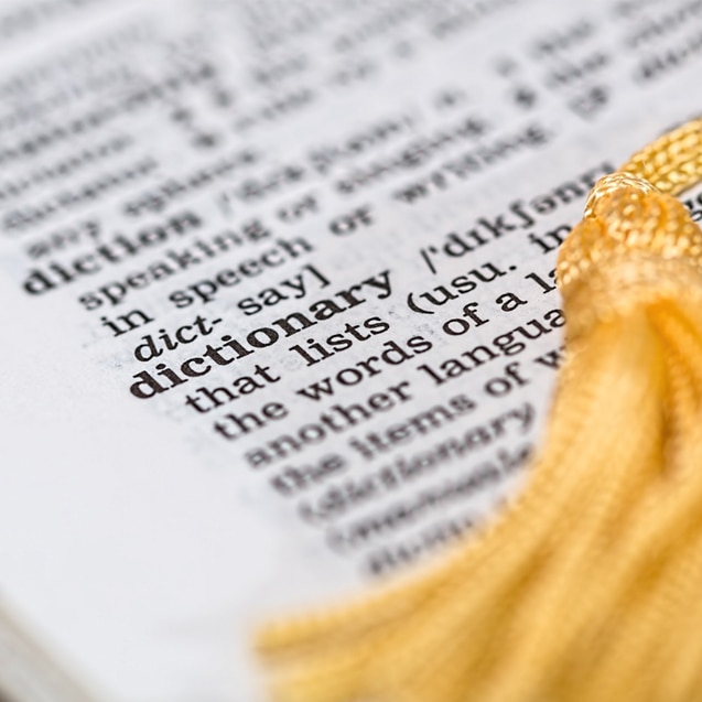 A yellow tassel marks an open page in a dictionary.