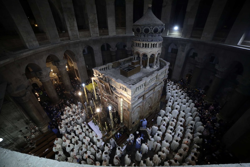 Catholic clergy walk during the Washing of the Feet procession at the Church of the Holy Sepulchre.