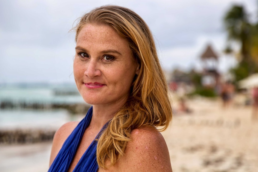 Wendy Dent is pictured standing on a beach