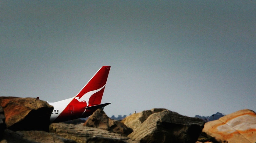 Wideshot of the tailplane of a Qantas jet (Getty Images: Ian Waldie)