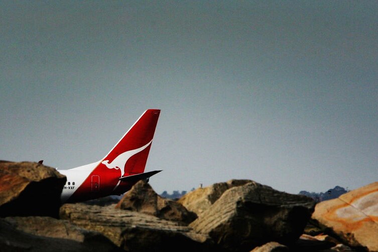 Wideshot of the tailplane of a Qantas jet (Getty Images: Ian Waldie)