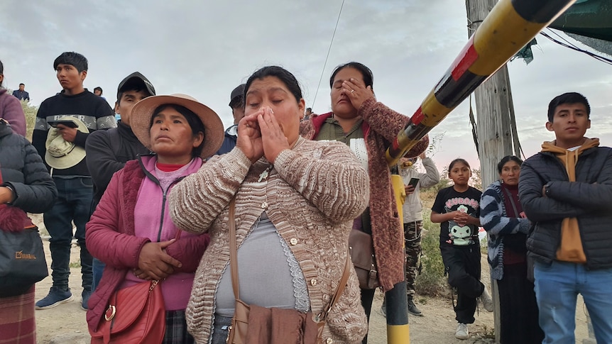 Distraught relatives of trapped miners gather outside a gold mine in Peru