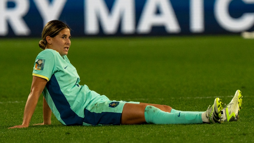 Matildas' Kyra Cooney-Cross sits on the grass after losing the third=place playoff to Sweden at the Women's World Cup..