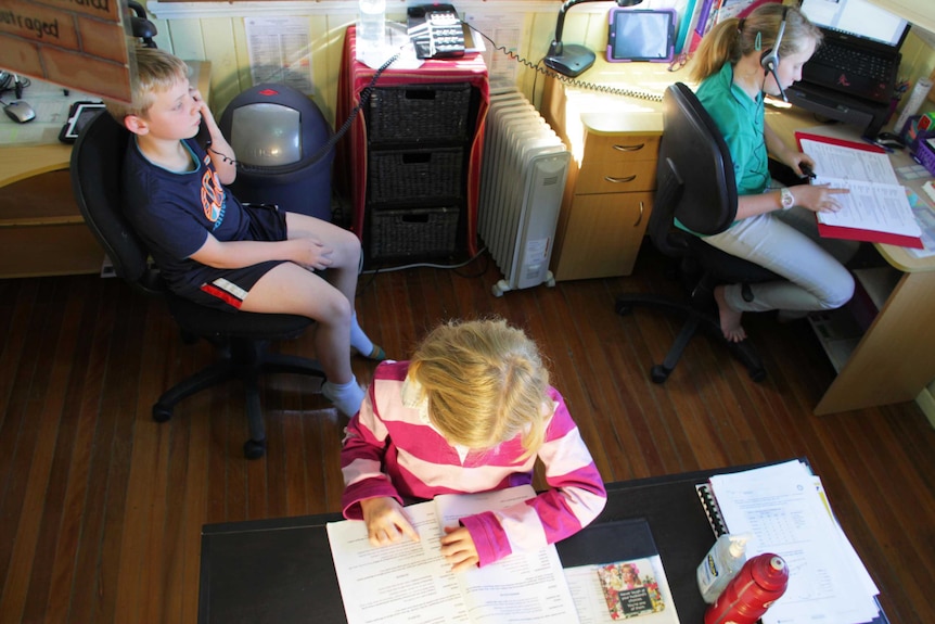 Shot of three students in a schoolroom.