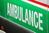 A close-up shot of the word 'ambulance' on the side of a St John WA ambulance.