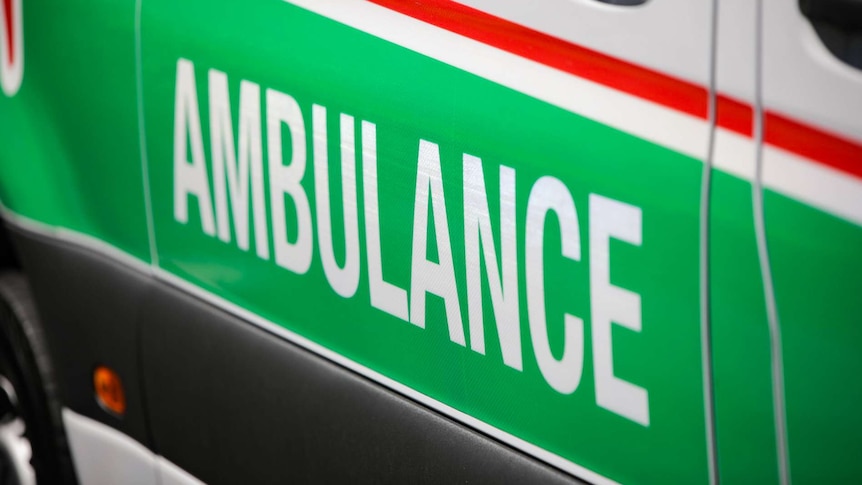 A close-up shot of the word 'ambulance' on the side of an ambulance.