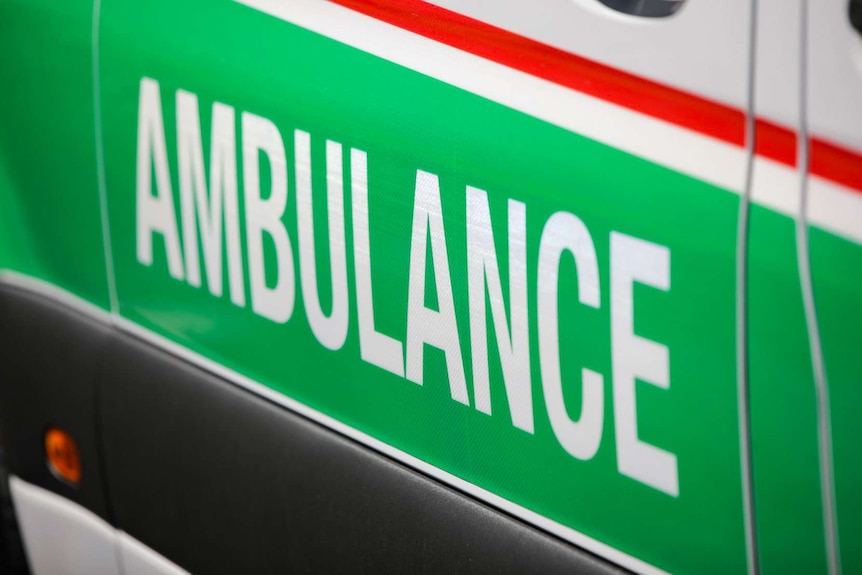 A close-up shot of the word 'ambulance' on the side of a St John WA ambulance.