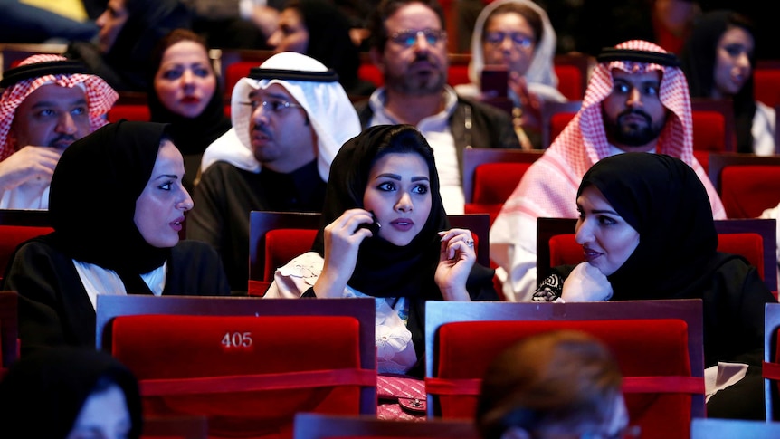 Saudi women sitting in a theatre.