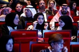 Saudi women sitting in a theatre.