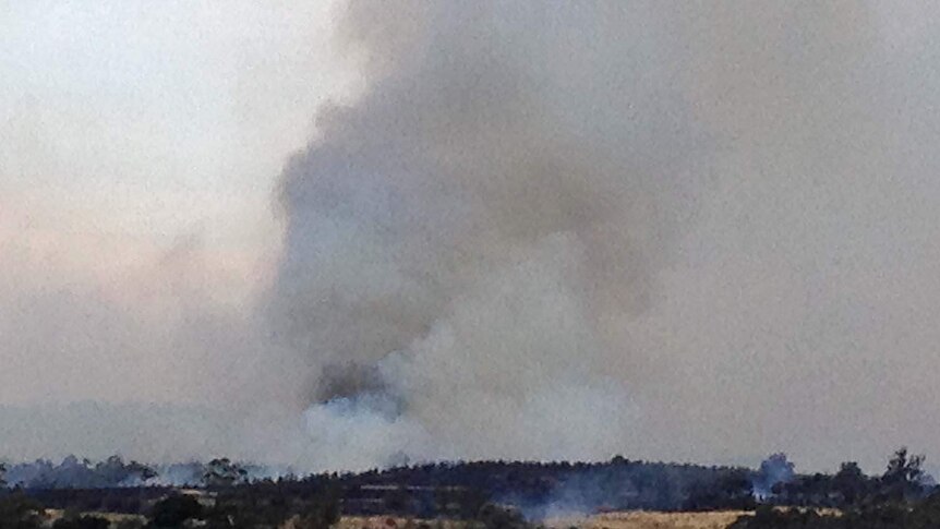 Smoke billows from a fire near Wattle Hill in south-east Tasmania.