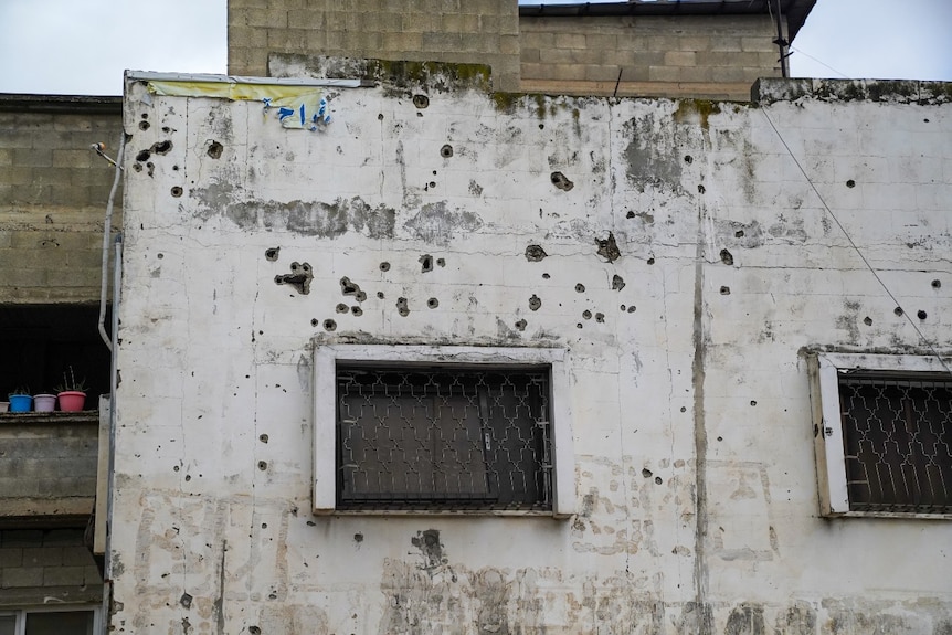 A wall with bullet holes in it