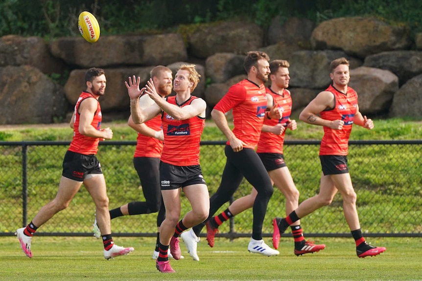 Conor McKenna trains with Essendon Bombers AFL teammates.
