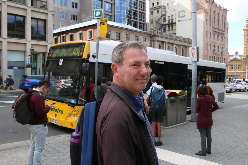 Rob Winterbottom waits for bus.