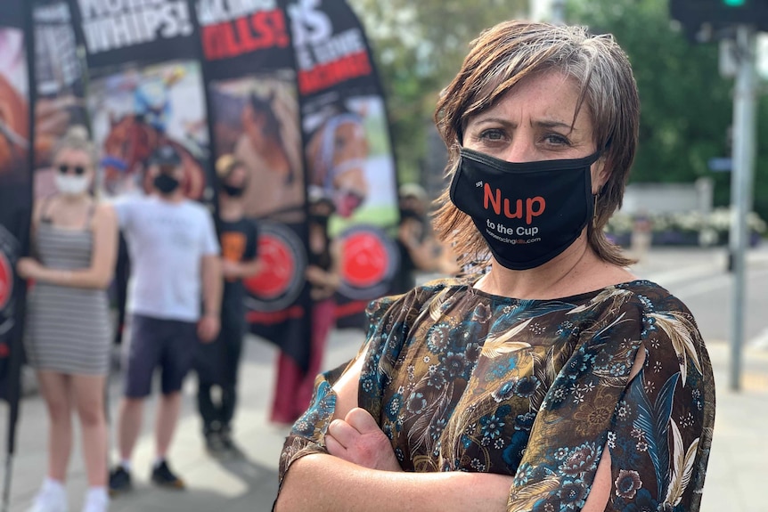Anti Melbourne Cup protester Kristin Leigh wearing a face mask that says "Nup to the Cup".