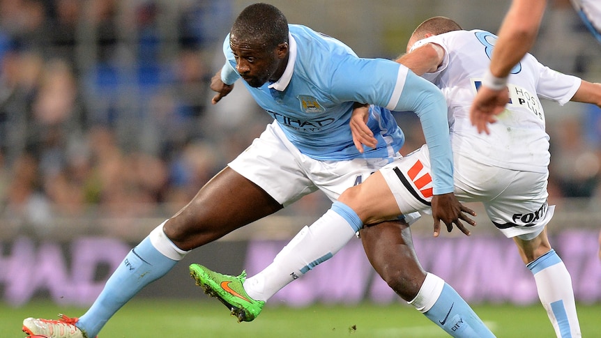 Yaya Toure of Manchester City takes on the defence