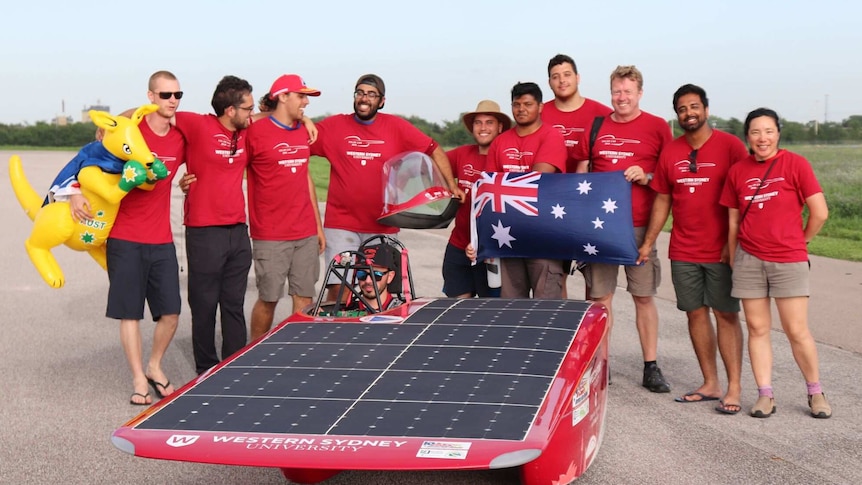 People in front of a solar car