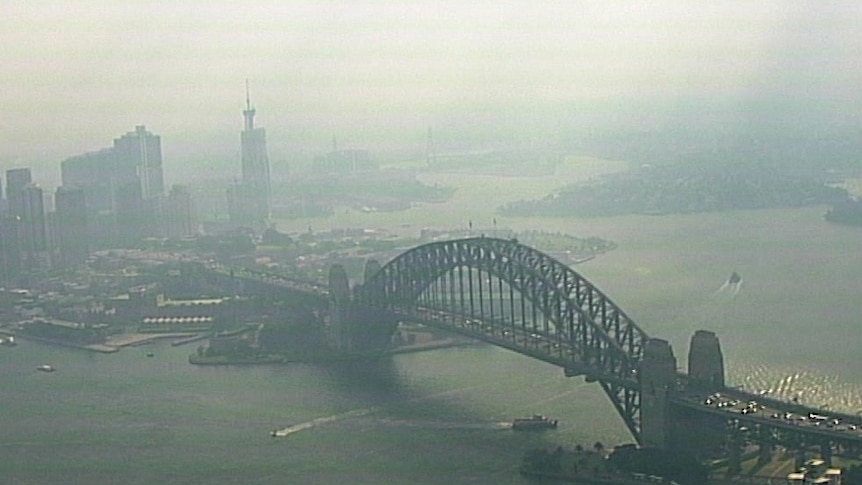 Aerial image of smoke over the Sydney Harbour Bridge looking west.