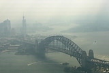 Aerial image of smoke over the Sydney Harbour Bridge looking west.