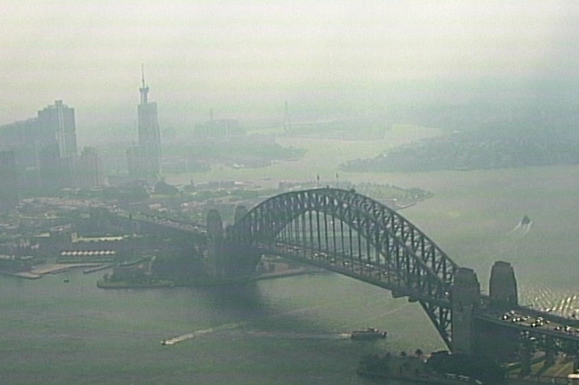 Aerial image of smoke over the Sydney Harbour Bridge looking west.