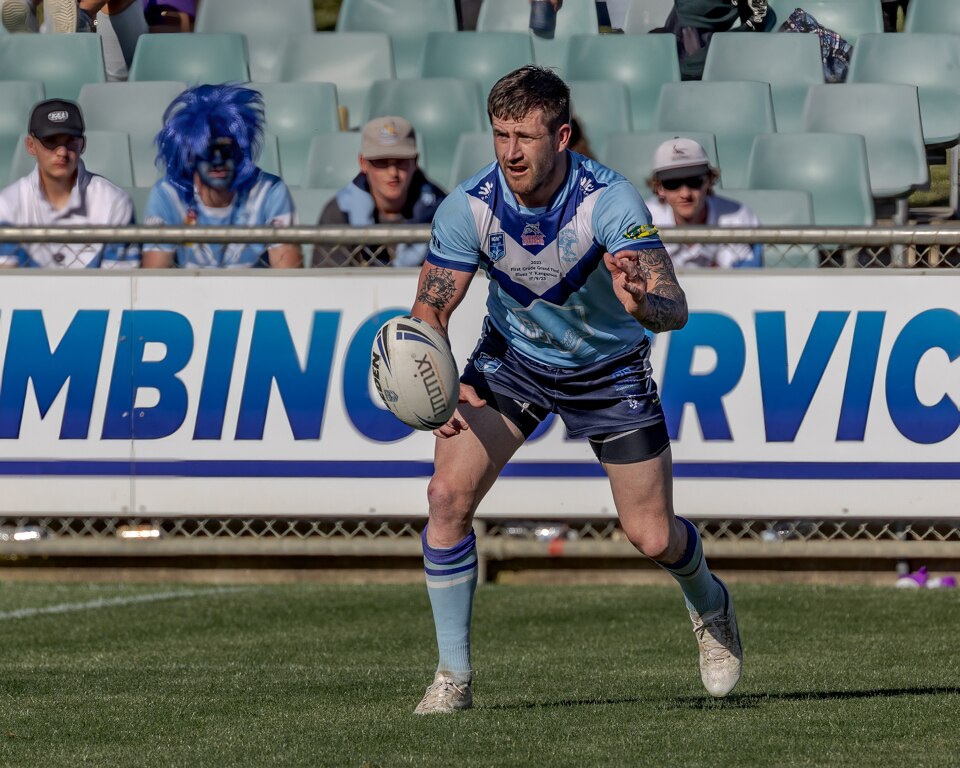 A man looks to pass during a rugby league match