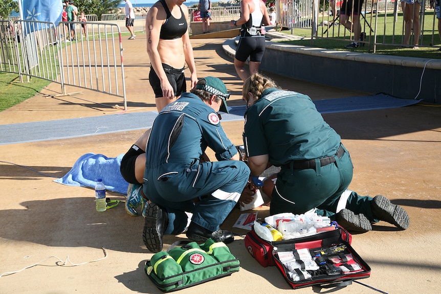Triathlete Raija Ogden is treated by first aid volunteers at the scene.