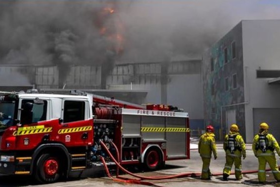 Firefights battling a factory fire