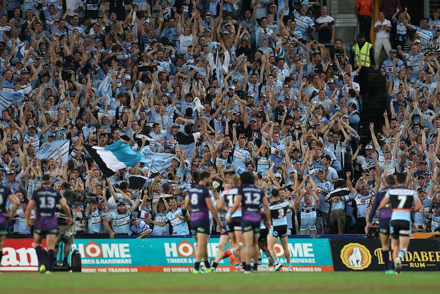 Sharks fans celebrate a try in the grand final
