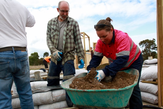 Kate and Scott Ryan-Taylor fill bags with earth for their earth bag home