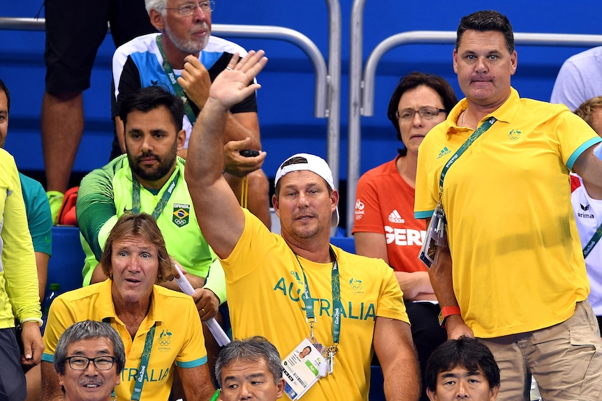 Australian swim coaches Denis Cotterell, Chris Mooney and Rohan Taylor react in the stands at the Rio Olympics.
