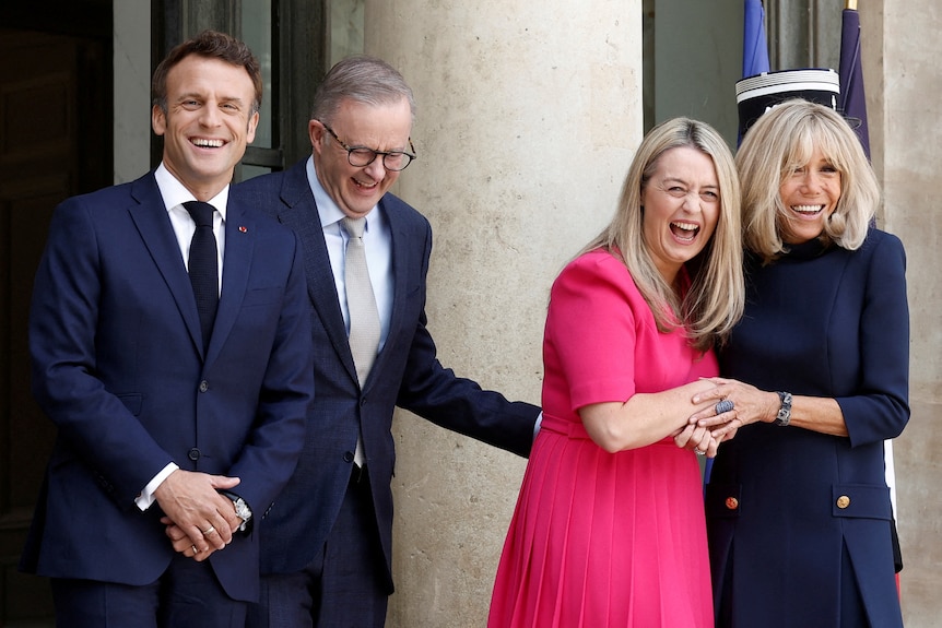 Two men and two women share a moment that makes them laugh and smile