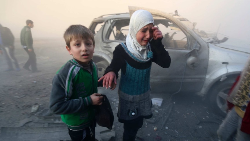 Syrian children near the site of a bomb attack in Aleppo