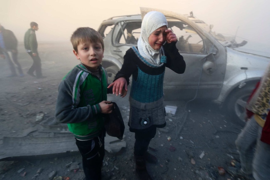 Syrian children near the site of a bomb attack in Aleppo