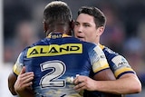 Two Parramatta NRL players hug as they celebrate the Eels' win over Manly.