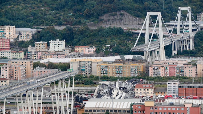 A wide, high view shows the length of collapsed part of the Morandi bridge.
